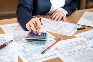 Person filling a tax form.