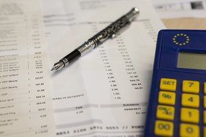 A VAT form with a fountain pen and a calculator