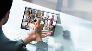 Close up of a man, seen from behind, attending an online meeting where everyone is using sign language.