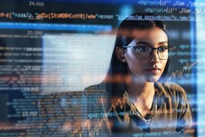 Photograph of a woman looking at a screen, with an overlay reflection of financial data
