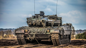 Photograph of a military tank in a sandy landscape.