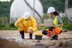Photograph of a female and a male environmental researcher analysing water samples and recording data