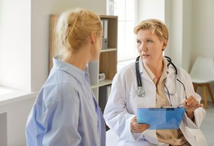 Female doctor and patient engage in  supportive conversation.