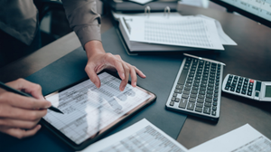 Investors working on desk office and use tablet to check tracking cost. Accounting and Financial concept.