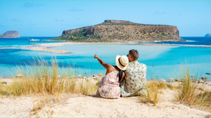 A man and a woman looking at an island on Balos lagoon island in Crete