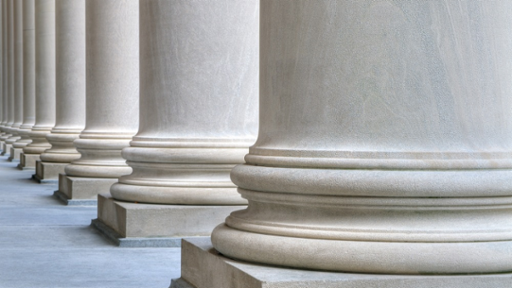 A row of tall, white stone columns.