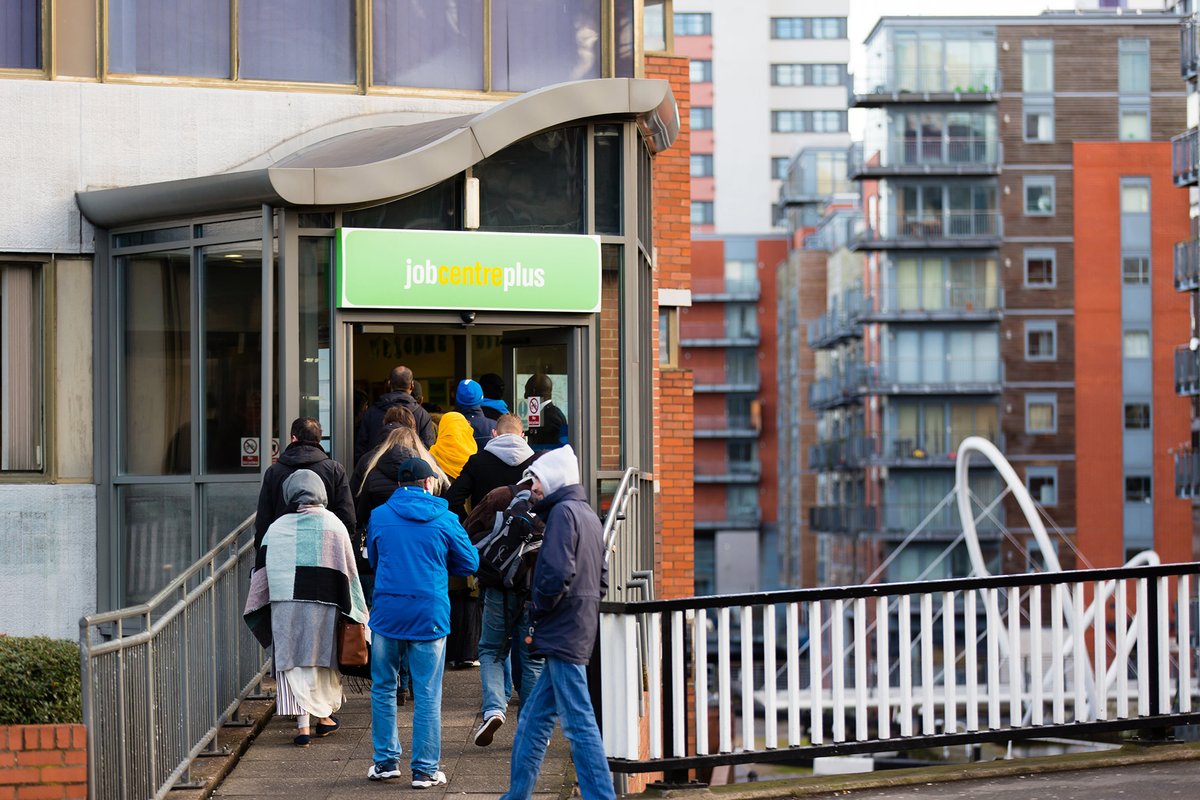 People waiting in line in front of a job centre