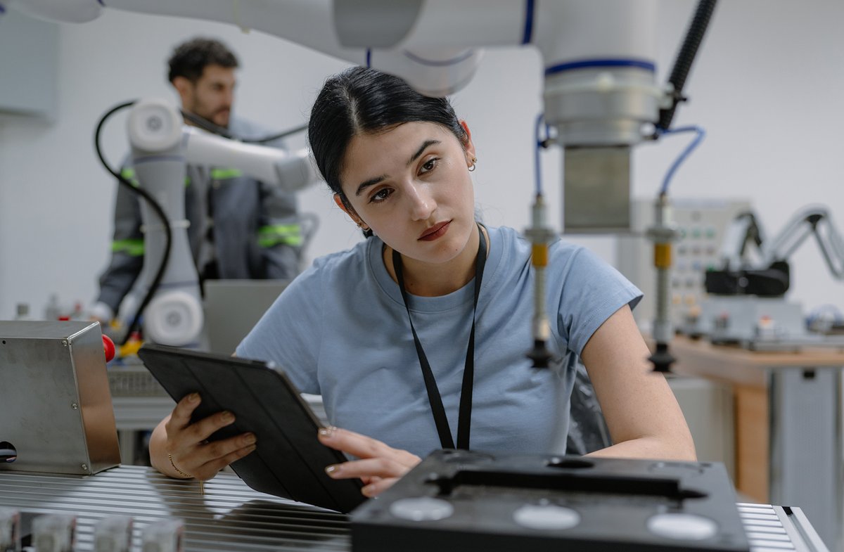Photograph of a female engineer working on technology in a laboratory setting.