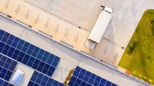 Industrial warehouses with solar panels viewed from above
