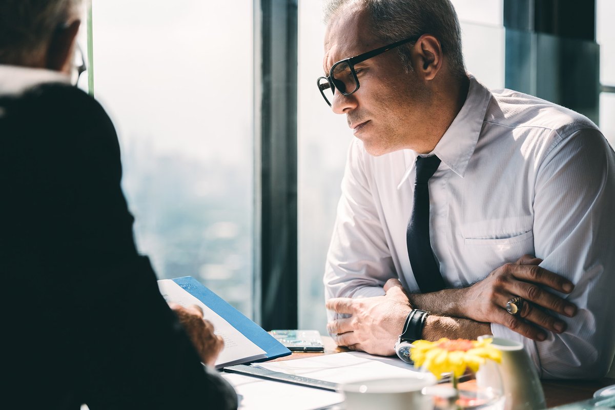 Two people working at a desk.