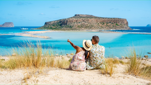 A man and a woman looking at an island on Balos lagoon island in Crete